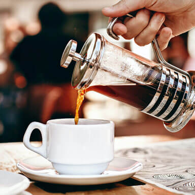 Tea being poured in a cup at bakeslice